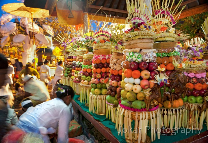 Odalan_Mas_20100523_102.jpg - 12. ODALAN MAS #2 - After carrying in their offerings atop their heads, women deposit their heavy offerings (including fruit, flowers, rice cakes, eggs, incense, sweets, barbecued chicken and ducks) on a platform inside the temple. Each offering is assembled by hand, with bamboo skewers used to attach the items to a central pillar of banana stem. Odalan (temple anniversary) celebrations, Mas village.