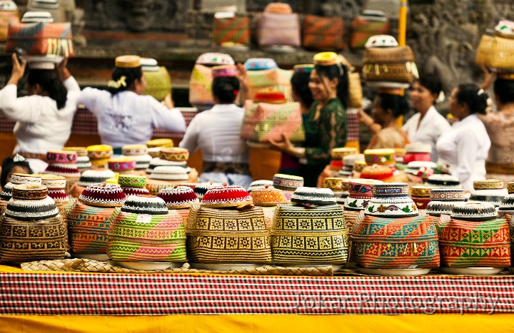 Pura_Dalem_20100803_070.jpg - 20. PURA DALEM, UBUD #2 - Women deposit the offerings they have carried on their heads to the Odalan (temple anniversary) at the Pura Dalem, Ubud. On top of each basket are the padded rings they use to help balance their load.